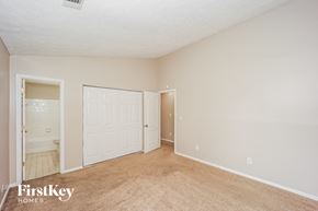 Stone Mountain house for rent - A bedroom with a carpeted floor and a white door.