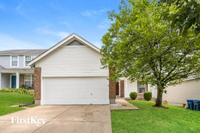 Black Jack house for rent - a white house with a white garage door and a tree