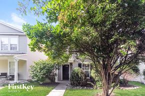 Fishers house for rent - A tree in front of a house with the words "FirstKey Homes" on it.
