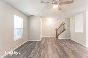 Fishers house for rent - A room with a wooden floor and a ceiling fan.