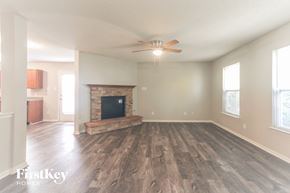 Fishers house for rent - A spacious living room with a fireplace and a television.