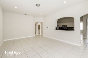 Miramar house for rent - an empty kitchen and living room with white tile floors and white walls