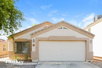 El Mirage house for rent - a home with a white garage door in front of it