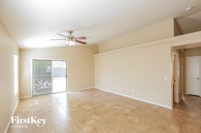 El Mirage house for rent - an empty living room with a ceiling fan