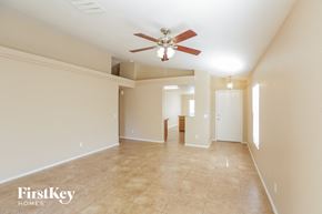 El Mirage house for rent - a large empty living room with a ceiling fan
