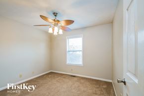 Fishers house for rent - a bedroom with a ceiling fan and a window