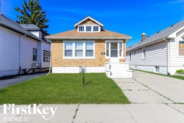 Waukegan house for rent - a brick house with a lawn in front of a sidewalk