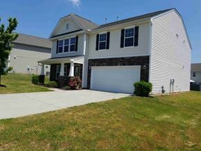 Greensboro house for rent - A two-story house with a garage door and a covered porch.