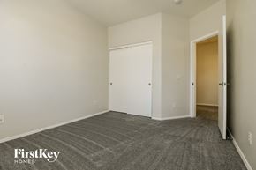 Surprise house for rent - a bedroom with a carpeted floor and a door to a closet