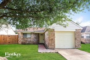 Houston house for rent - A house with a garage door is for sale.