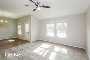 Royse City house for rent - a living room with a ceiling fan and a window