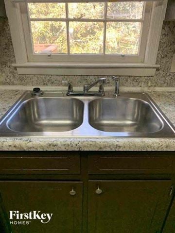 Conyers house for rent - a stainless steel kitchen sink under a window