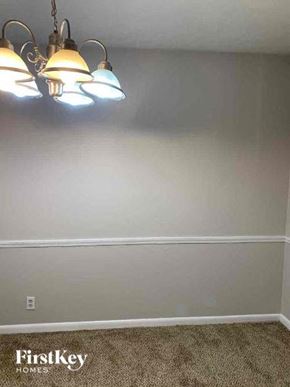Conyers house for rent - a room with three lights on the ceiling and a carpet