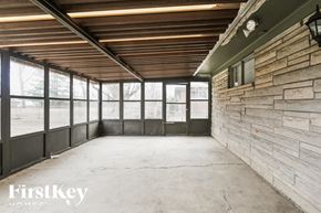 Indianapolis house for rent - A large, empty room with a stone wall and a wooden ceiling.