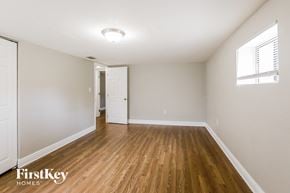 Miami house for rent - the living room of an apartment with wood flooring and white walls