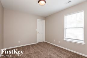 Huntersville house for rent - a bedroom with a carpeted floor and a white door
