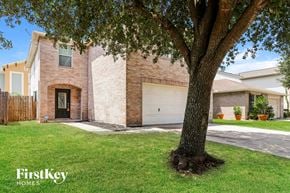 Houston house for rent - A tree in front of a house with the words "FirstKey Homes" on the bottom left.
