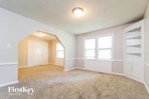Grandview house for rent - A carpeted room with a doorway leading to another room.