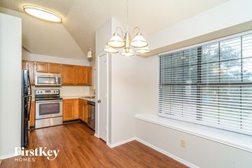 Lewisville house for rent - A kitchen with wooden cabinets and stainless steel appliances.