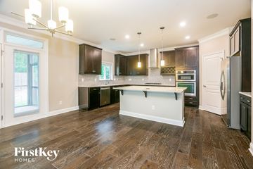 Wake Forest house for rent - a kitchen with dark wood cabinets and a white counter top