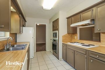 Houston house for rent - a kitchen with wooden counter tops and stainless steel appliances