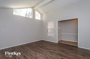 Houston house for rent - the living room of an apartment with a wood floor and a door to a closet