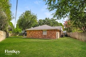 Houston house for rent - a small brick house in the middle of a grassy yard