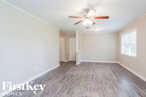 Houston house for rent - a living room with a ceiling fan and a wood floor