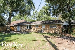 Houston house for rent - a small brick house with a yard and trees