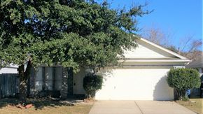Houston house for rent - A white house with a tree in front.
