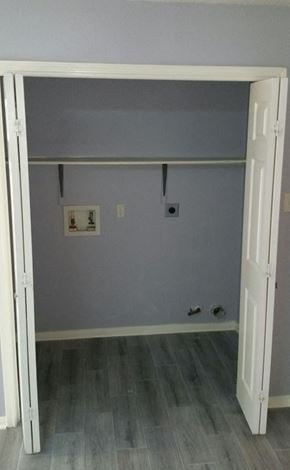 Houston house for rent - A white door is open to a room with a grey wall and a white switch plate.