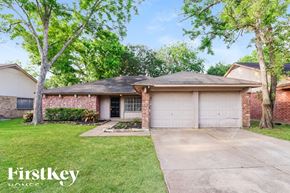 Houston house for rent - A brick house with a white garage door is for sale.