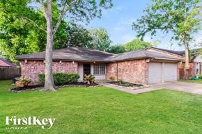 Houston house for rent - A brick house with a tree in front of it.