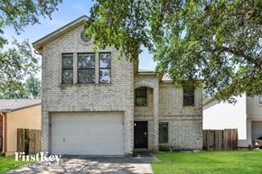 San Antonio house for rent - A brick house with a white garage door is for sale.