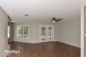 San Antonio house for rent - A room with a ceiling fan and sliding glass doors.