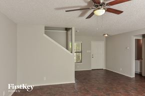 San Antonio house for rent - A room with a fan and a staircase.