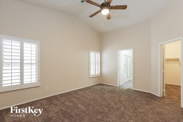Surprise house for rent - a living room with a ceiling fan and a carpet