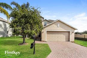 New Port Richey house for rent - A house with a garage and a tree in front of it.