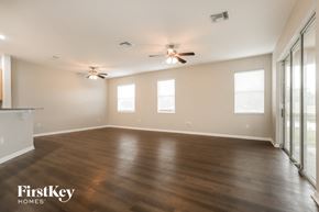 New Port Richey house for rent - A spacious room with wooden flooring and a ceiling fan.