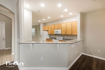 New Port Richey house for rent - A kitchen with a white counter and wooden cabinets.