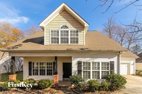 Huntersville house for rent - the front of a house with a front porch and a garage
