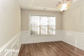 Huntersville house for rent - a dining room with white walls and wood flooring and a window
