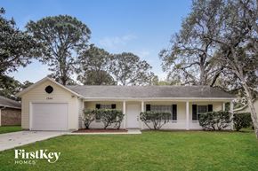 Palm Bay house for rent - a white house with a lawn and trees