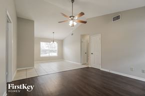 Palm Bay house for rent - an empty living room with wood floors and a ceiling fan