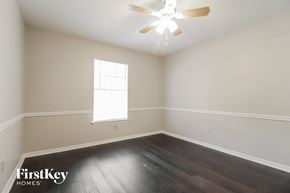Palm Bay house for rent - a bedroom with hardwood flooring and a ceiling fan