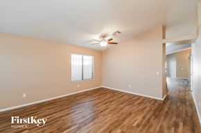 San Tan Valley house for rent - an empty living room with wood flooring and a ceiling fan