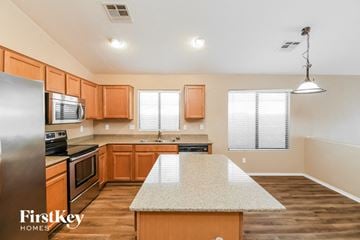 San Tan Valley house for rent - a kitchen with wooden cabinets and a white counter top