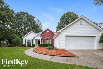 Loganville house for rent - a home with a garden in front of it