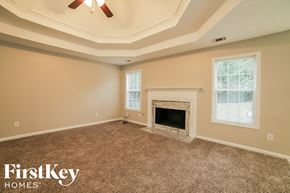 Loganville house for rent - the living room of an empty house with a fireplace