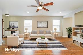 Houston house for rent - A living room with a white couch, a coffee table, and a ceiling fan.